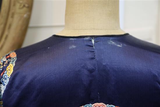 A Chinese noblewomans embroidered silk midnight blue surcoat (longgua), late 19th century, 138cm long, minor alterations to sleeves an